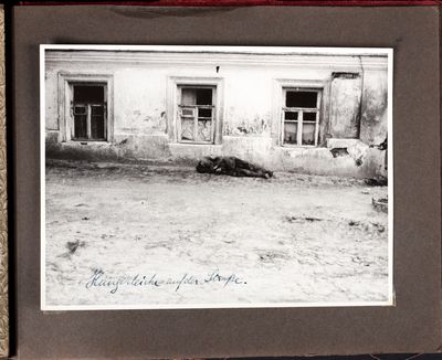 Victim of starvation lies dead against the side of a building in Kharkiv