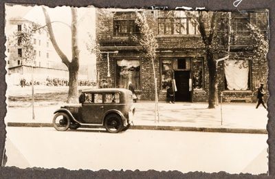 Street view of a “Torgsin” store in Kharkiv, with a car parked in front