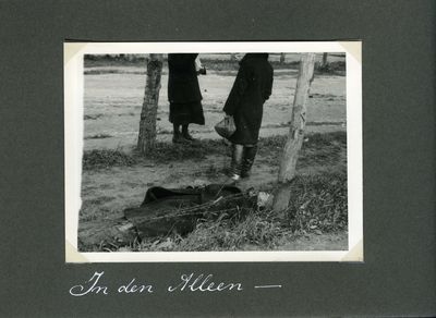 Two women standing near the body of a starvation victim in Kharkiv