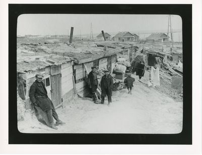 A handful of youngsters stand near their homes built for workers at the Dnipro Hydroelectric Dam