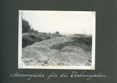 Mass grave burial site on the outskirts of Kharkiv with a gravedigger at work