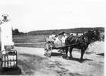 Horse and buggy by gas pumps, Dean Lake, 1954