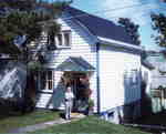 House 4 Fairy Avenue, Huntsville, Ontario, Walter Johns in front of doorway, 1975.