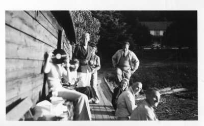 Group portrait at boathouse of Methven Cottage, Fairy Lake, Huntsville, Ontario, 1934.