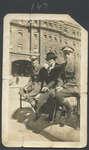 Three Unidentified People Sitting on a Bench