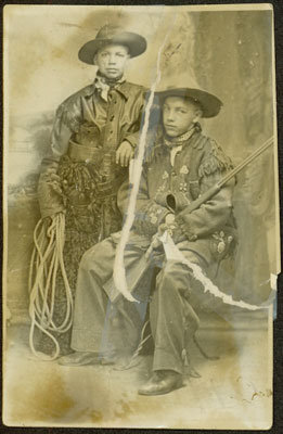 Two Boys Dressed Like Cowboys