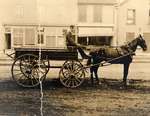 Man in horse-drawn wagon on King Street, Waterloo, Ontario