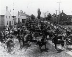 Crowd waiting for arrival of farm machinery parts at George A. Tilt's implement dealership in Blair, Ontario