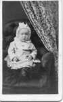 Unidentified child seated in chair, Lucan, Ontario