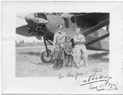 The Sir John Carling airplane with pilot, Terrence Tully and navigator, James V. Medcalf posing with two unidentified boys, London, Ontario