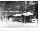 Workman shovelling snow off streetcar tracks near the southwest corner of Dundas and Richmond Streets, London, Ontario