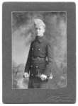Portrait of an unidentified young man wearing a Persian lamb cap and military overcoat, Toronto, Ontario