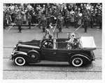 Royal Visit, 1939 - King George VI and Queen Elizabeth in limousine passing in front of crowd and soldiers with swords, London, Ontario