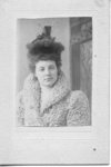 Portrait of an unidentified young woman in a persian wool coat wearing a fur and feather hat, London, Ontario