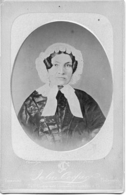 Portrait of an unidentified dark haired woman in a lace edged bonnet, London, Ontario.