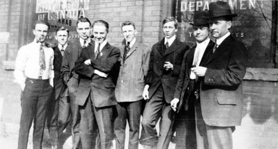 Group of eight men standing in front of Royal Bank of Canada building