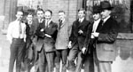 Group of eight men standing in front of Royal Bank of Canada building