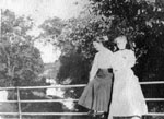 Two women posed on railing
