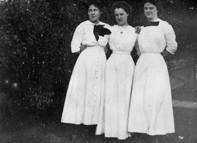 Three women in white dresses