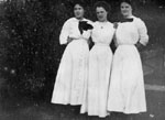 Three women in white dresses