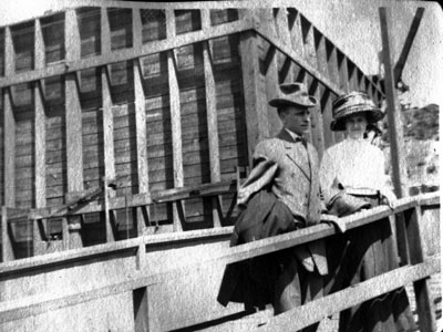 Man and woman on gang plank of boat