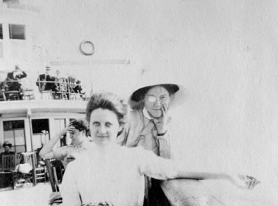 Two women leaning on rail of boat