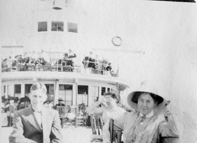 Man and woman seated on deck