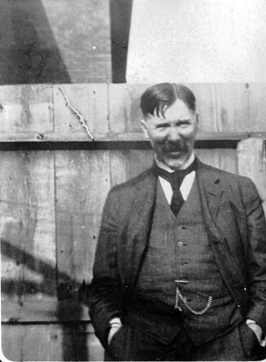 Middle-aged man posed in front of fence