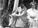 Two women sitting on steps of porch