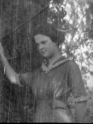 Young lady posed by tree