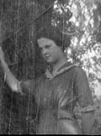 Young lady posed by tree