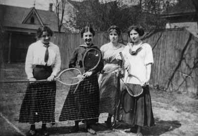 Four young ladies with tennis racquets