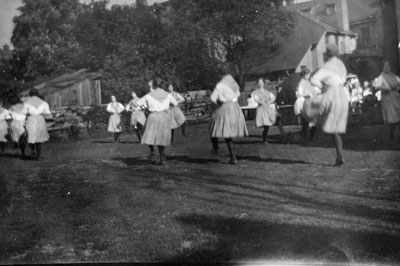 Women dancing on lawn