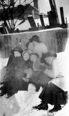 Six women posed on snow bank