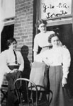 Three women posed by window
