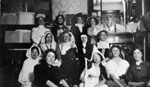 Group of women posed by fireplace