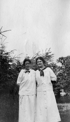 Two ladies dressed in white