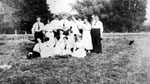 Group of young men and women posed in field