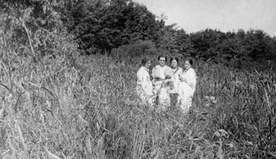 Women and children posed in field