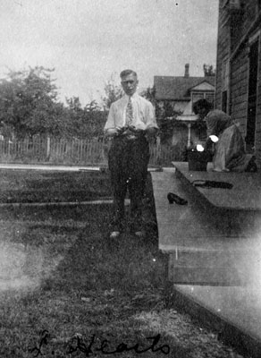 Man standing by steps of house