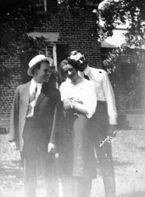 Two men and a woman standing in garden