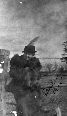 Woman posed by fence