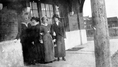 Group of four women waiting on station platform