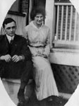 Young man and woman sitting on porch steps