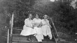 Three young women sitting on steps