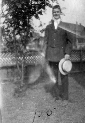 Young man holding hat