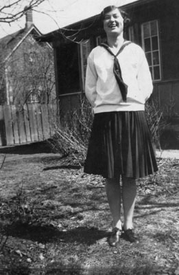 Young lady posed in front of buildings