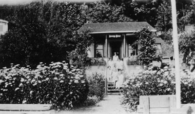 Group of women posed on cottage steps