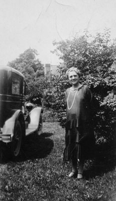 Lady standing by car