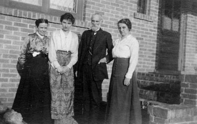 Group posed by house